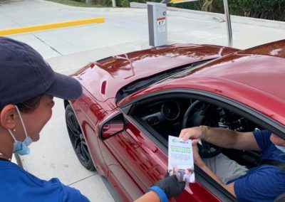 International Auto Spa employee handing out a flyer
