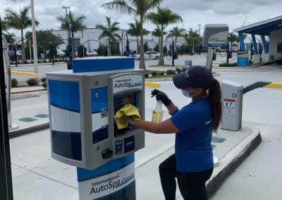 International Auto Spa employee cleaning the paystation